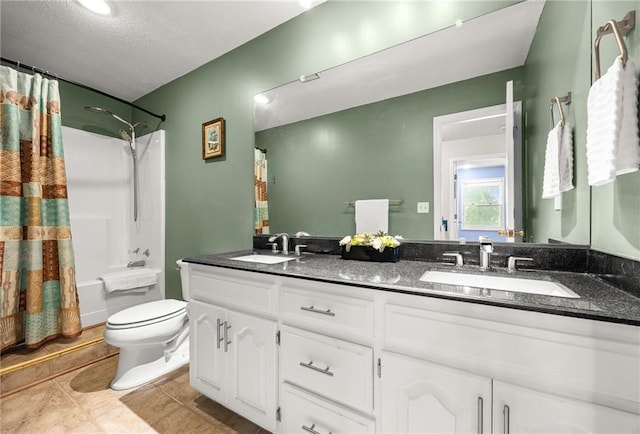 1305 N Hunter Dr, Olathe, KS 66061 - bathroom featuring double vanity, shower / bath combo with shower curtain, tile patterned floors, and a textured ceiling