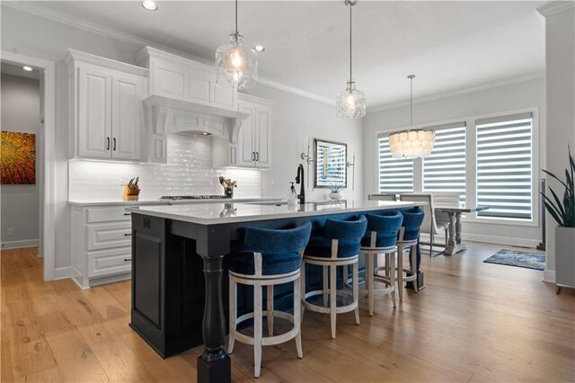 13389 W 147th Ter, Olathe, KS 66062 - kitchen with light countertops, recessed lighting, white cabinetry, tasteful backsplash, and an island with sink