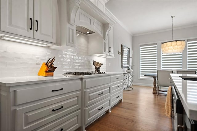 13389 W 147th Ter, Olathe, KS 66062 - kitchen with gas cooktop, light countertops, tasteful backsplash, crown molding, and a chandelier