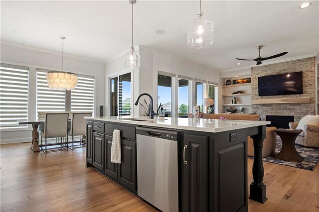 13389 W 147th Ter, Olathe, KS 66062 - kitchen with stainless steel dishwasher, a kitchen island with sink, light countertops, open floor plan, and ceiling fan