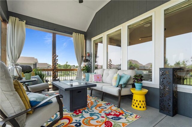 13389 W 147th Ter, Olathe, KS 66062 - sunroom / solarium with lofted ceiling, an outdoor living space with a fire pit, and concrete flooring