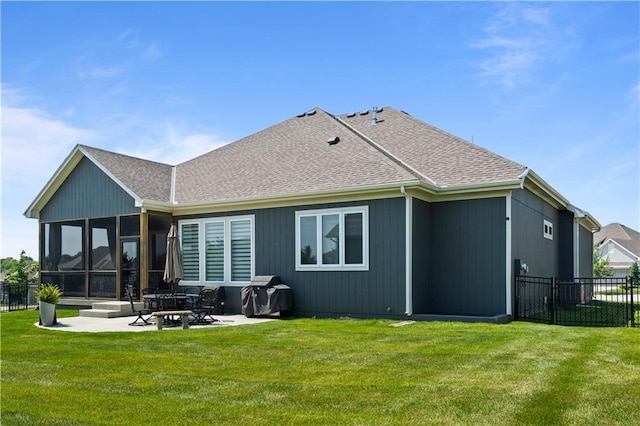 13389 W 147th Ter, Olathe, KS 66062 - back of house featuring a shingled roof, a patio, and a sunroom
