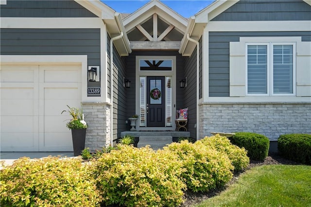 13389 W 147th Ter, Olathe, KS 66062 - view of exterior entry featuring a garage and stone siding