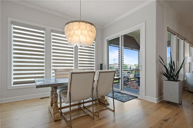 13389 W 147th Ter, Olathe, KS 66062 - dining space with a chandelier, ornamental molding, healthy amount of natural light, and light wood-style floors
