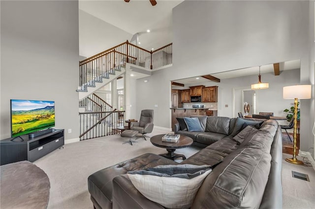 2301 NE 110th St, Kansas City, MO 64155 - living area featuring carpet floors, stairs, and high vaulted ceiling