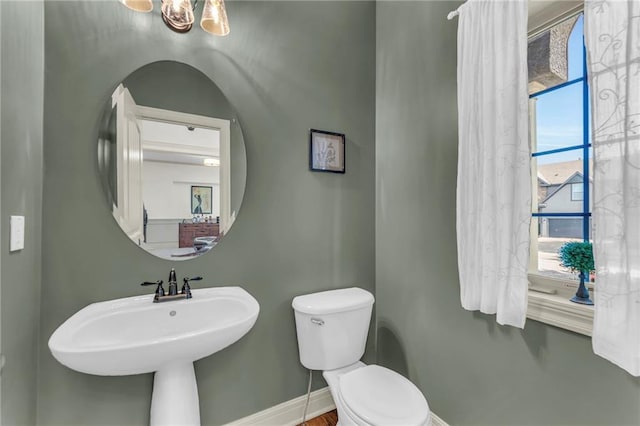 2301 NE 110th St, Kansas City, MO 64155 - bathroom featuring toilet and a chandelier