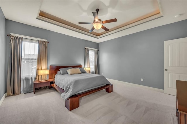 2301 NE 110th St, Kansas City, MO 64155 - carpeted bedroom featuring a raised ceiling, multiple windows, and ceiling fan