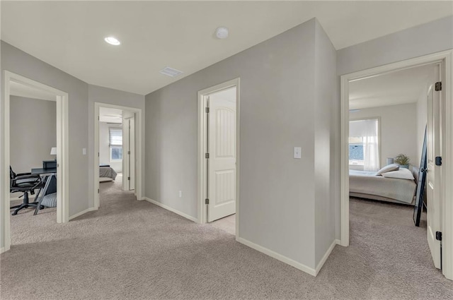 2301 NE 110th St, Kansas City, MO 64155 - hall featuring light carpet, a desk, and recessed lighting