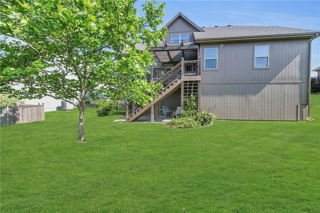 2301 NE 110th St, Kansas City, MO 64155 - back of property with stairway, a wooden deck, and roof with shingles