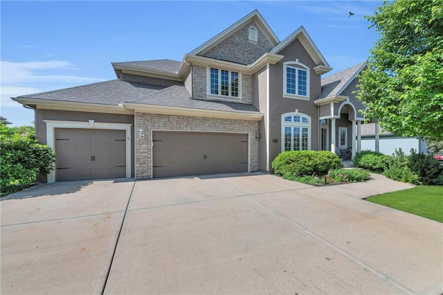 2301 NE 110th St, Kansas City, MO 64155 - view of front of home featuring stone siding, concrete driveway, a garage, stucco siding, and a shingled roof