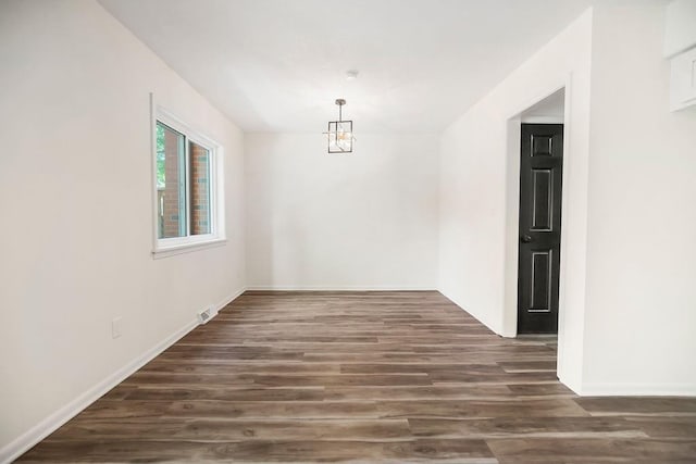 9599 Outlook Dr, Overland Park, KS 66207 - unfurnished dining area featuring wood finished floors, baseboards, and a chandelier