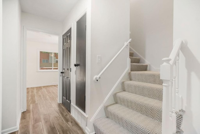 9599 Outlook Dr, Overland Park, KS 66207 - staircase with wood finished floors and baseboards