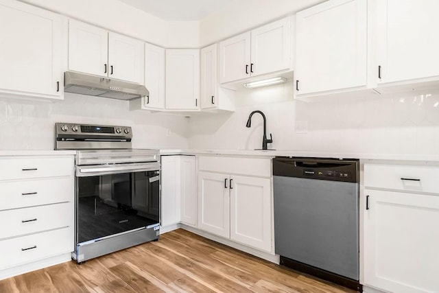 9599 Outlook Dr, Overland Park, KS 66207 - kitchen featuring stainless steel appliances, under cabinet range hood, a sink, and white cabinets