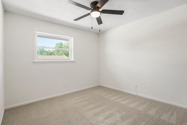 9599 Outlook Dr, Overland Park, KS 66207 - unfurnished room featuring light colored carpet, baseboards, a ceiling fan, and a textured ceiling