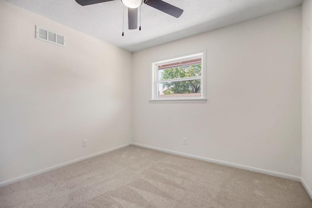 9599 Outlook Dr, Overland Park, KS 66207 - spare room featuring light colored carpet, baseboards, ceiling fan, and a textured ceiling