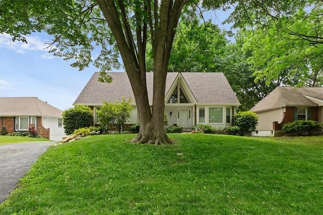12509 W 100th Ter, Lenexa, KS 66215 - view of front facade with a front yard and asphalt driveway