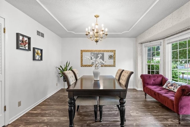 12509 W 100th Ter, Lenexa, KS 66215 - dining room with a raised ceiling, wood finished floors, a chandelier, and a textured ceiling