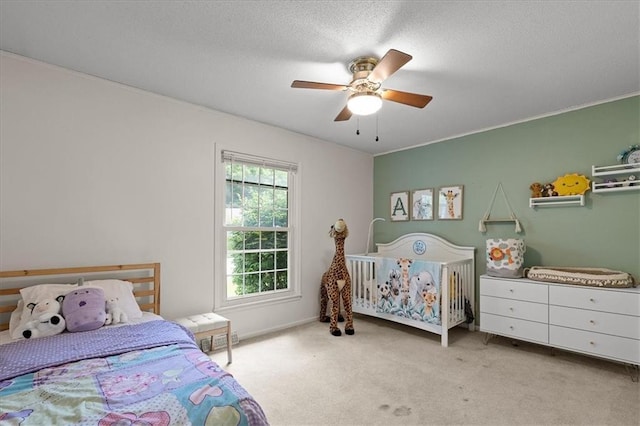12509 W 100th Ter, Lenexa, KS 66215 - carpeted bedroom featuring a ceiling fan and a textured ceiling