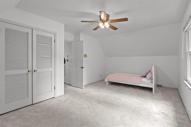 12509 W 100th Ter, Lenexa, KS 66215 - bedroom featuring carpet flooring, vaulted ceiling, a closet, and ceiling fan