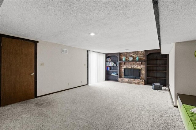 12509 W 100th Ter, Lenexa, KS 66215 - unfurnished living room with a textured ceiling, a brick fireplace, carpet, and built in features