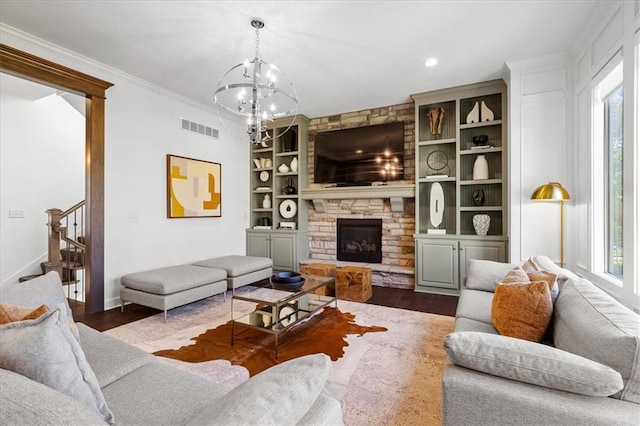 15945 W 165th St, Olathe, KS 66062 - living area with healthy amount of natural light, dark wood-style flooring, a chandelier, built in features, and crown molding