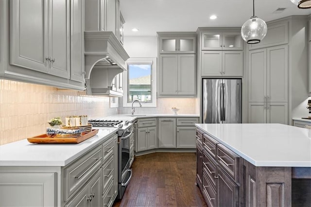 15945 W 165th St, Olathe, KS 66062 - kitchen featuring stainless steel appliances, gray cabinetry, light countertops, dark wood finished floors, and backsplash