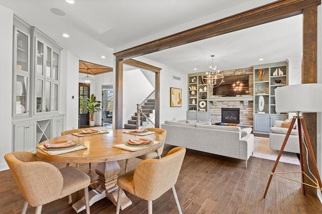 15945 W 165th St, Olathe, KS 66062 - dining room with a chandelier, stairs, recessed lighting, dark wood finished floors, and built in features