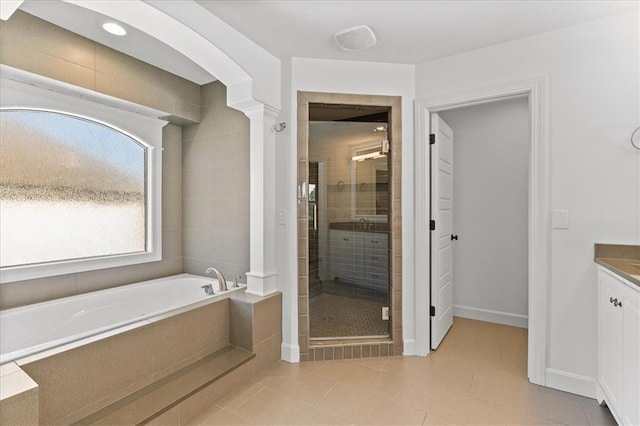 15945 W 165th St, Olathe, KS 66062 - full bathroom featuring a shower stall, vanity, a garden tub, baseboards, and tile patterned floors
