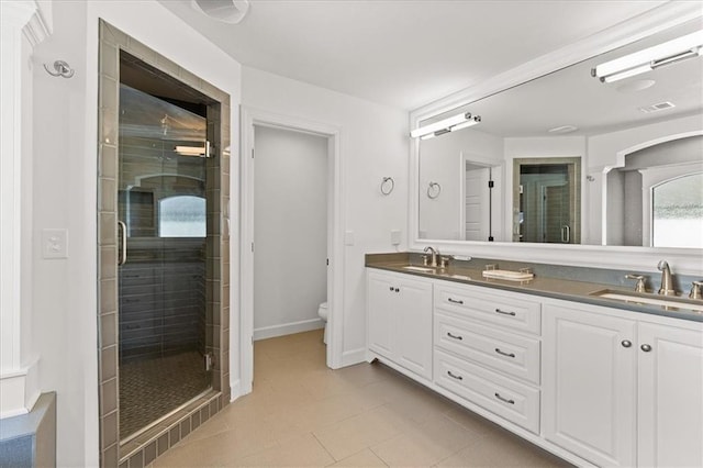 15945 W 165th St, Olathe, KS 66062 - full bathroom featuring double vanity, toilet, a stall shower, tile patterned flooring, and baseboards