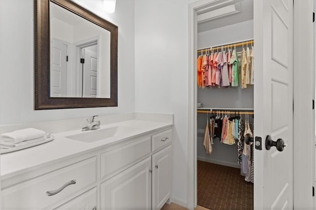 15945 W 165th St, Olathe, KS 66062 - bathroom with vanity, a spacious closet, and baseboards