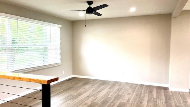 1636 S Poplar St, Ottawa, KS 66067 - unfurnished room featuring ceiling fan, baseboards, wood finished floors, and recessed lighting
