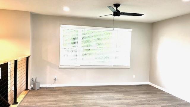 1636 S Poplar St, Ottawa, KS 66067 - unfurnished living room featuring ceiling fan, wood finished floors, baseboards, and recessed lighting