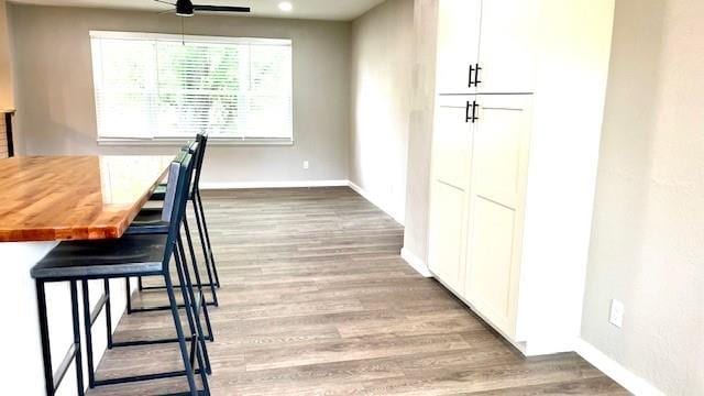 1636 S Poplar St, Ottawa, KS 66067 - dining space with wood finished floors, baseboards, and ceiling fan