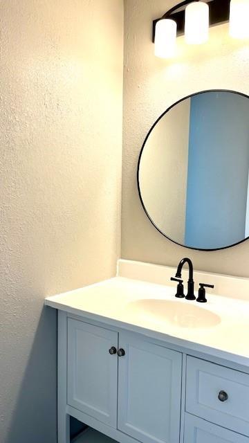 1636 S Poplar St, Ottawa, KS 66067 - bathroom with vanity and a textured wall