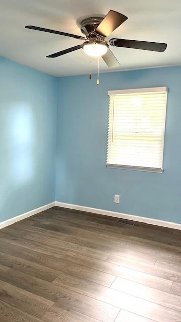 1636 S Poplar St, Ottawa, KS 66067 - unfurnished room featuring wood finished floors, a ceiling fan, and baseboards