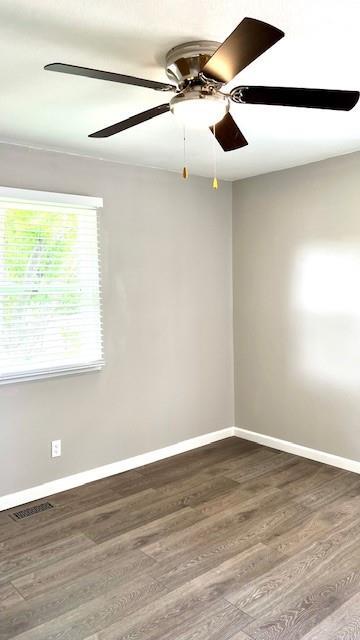 1636 S Poplar St, Ottawa, KS 66067 - empty room featuring dark wood-type flooring, baseboards, and ceiling fan