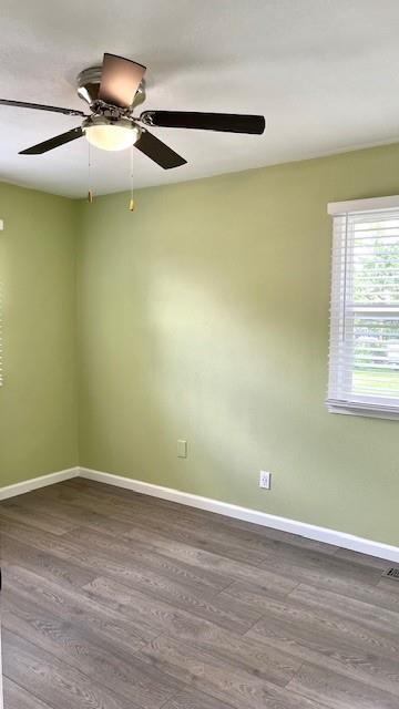 1636 S Poplar St, Ottawa, KS 66067 - unfurnished room with dark wood finished floors, baseboards, and a ceiling fan