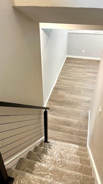 1636 S Poplar St, Ottawa, KS 66067 - stairway featuring wood finished floors and baseboards