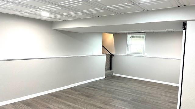 1636 S Poplar St, Ottawa, KS 66067 - basement featuring baseboards, wood finished floors, and stairway