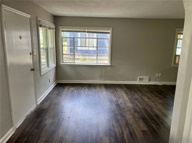 6823 S Benton Ave, Kansas City, MO 64132 - empty room with dark wood-style flooring, a textured ceiling, and baseboards