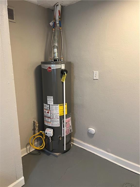 6823 S Benton Ave, Kansas City, MO 64132 - utility room featuring water heater