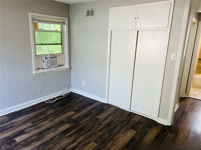 6823 S Benton Ave, Kansas City, MO 64132 - unfurnished bedroom featuring dark wood-type flooring, cooling unit, and baseboards