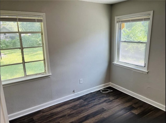 6823 S Benton Ave, Kansas City, MO 64132 - spare room with dark wood-type flooring and baseboards