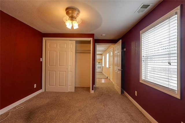 814 E Hayward Ave, Independence, MO 64050 - unfurnished bedroom featuring light colored carpet, a closet, and baseboards