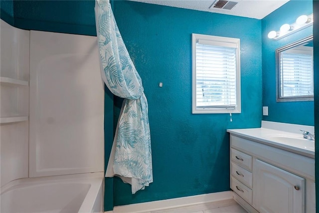 814 E Hayward Ave, Independence, MO 64050 - bathroom with vanity, bathtub / shower combination, and baseboards