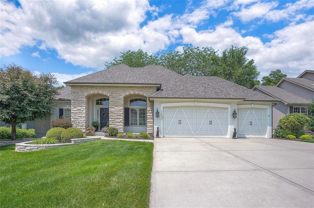 14630 NW 66th St, Parkville, MO 64152 - view of front of home featuring a garage, driveway, a front yard, and roof with shingles