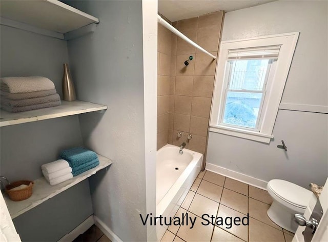 7216 Indiana Ave, Kansas City, MO 64132 - bathroom featuring toilet, shower / tub combination, tile patterned floors, and baseboards