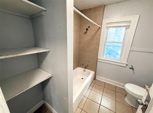 7216 Indiana Ave, Kansas City, MO 64132 - full bath featuring toilet, shower / tub combination, tile patterned floors, a textured ceiling, and baseboards