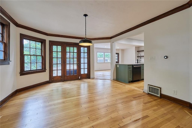 918 W 32nd Ter, Kansas City, MO 64111 - unfurnished dining area with crown molding, baseboards, light wood-style floors, and a sink