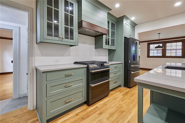 918 W 32nd Ter, Kansas City, MO 64111 - kitchen with green cabinets, high quality fridge, range with two ovens, light countertops, and light wood-type flooring